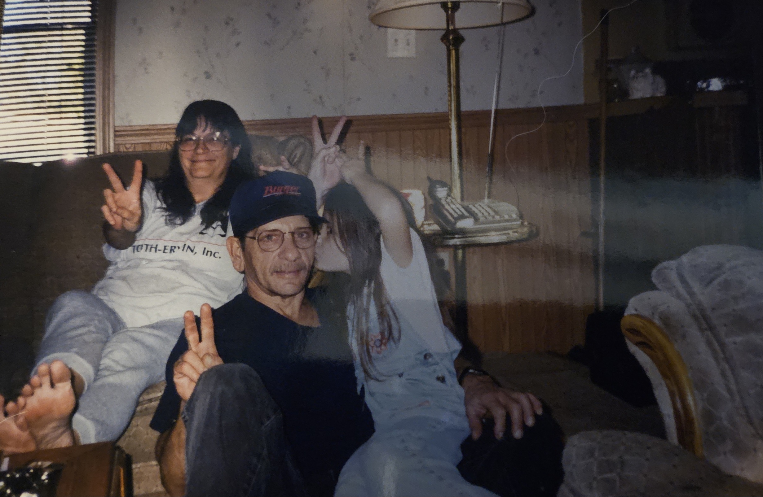 Gary, Caroline, and a child making peace signs