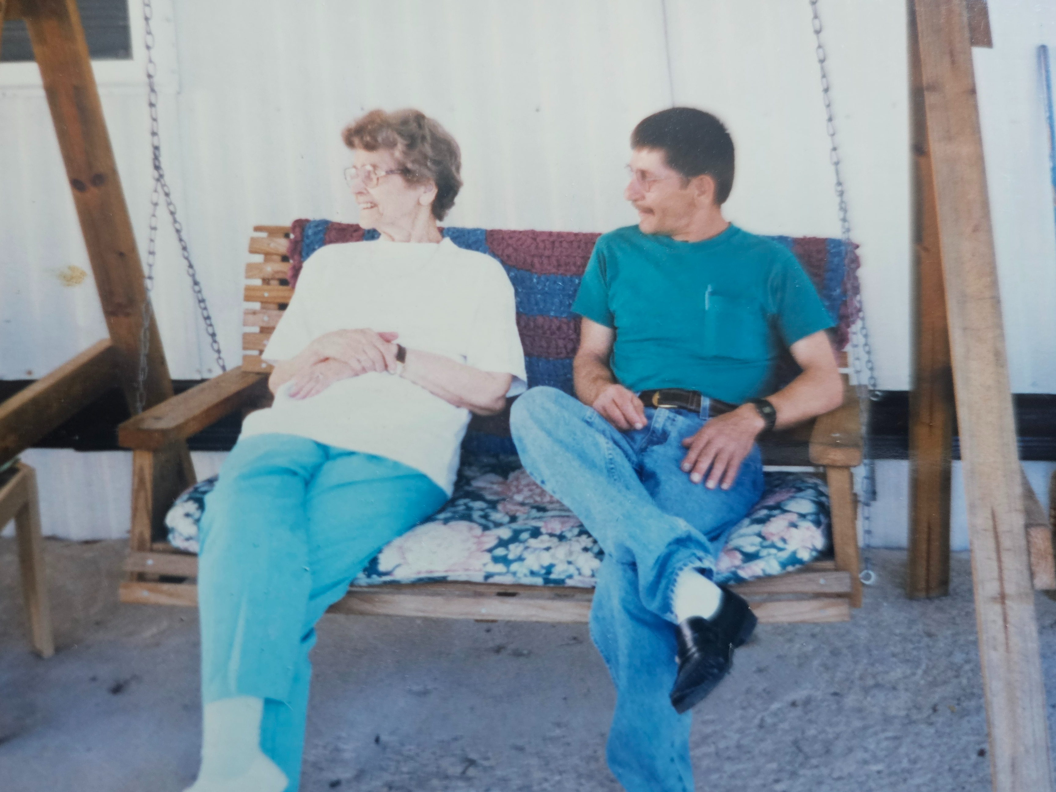 Gary with woman on porch swing
