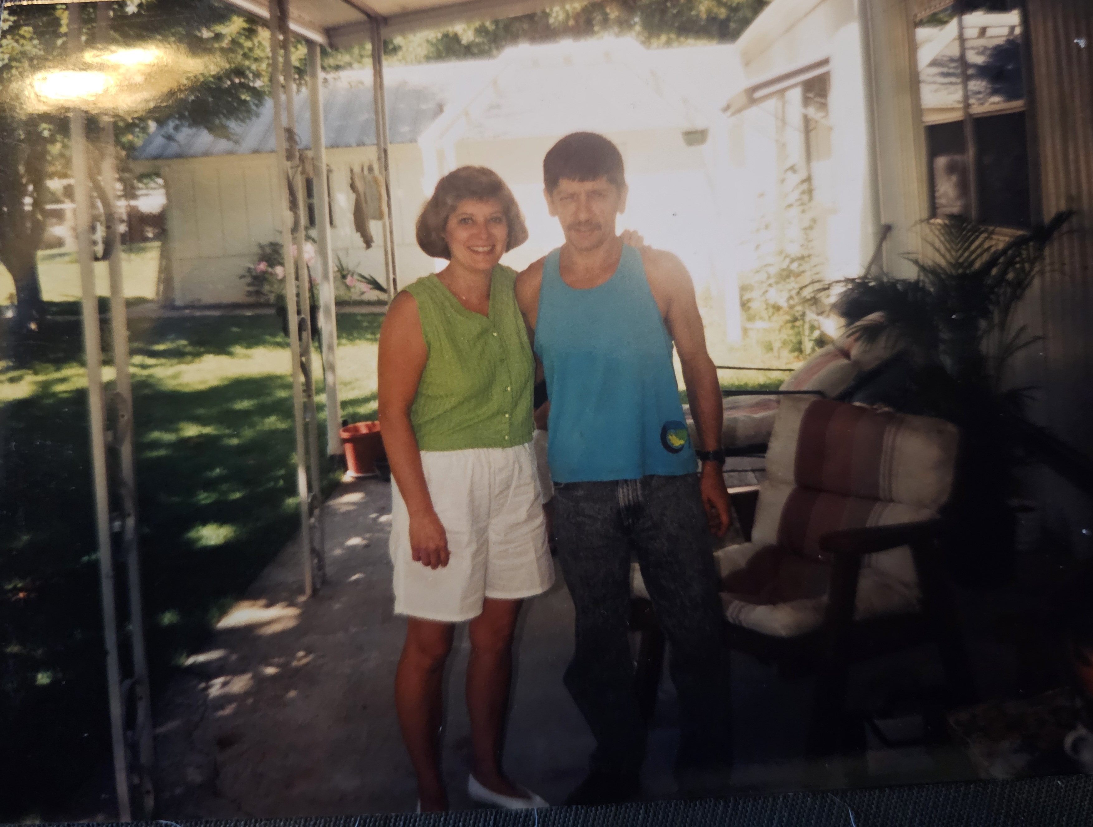 Patty and Gary smiling on a porch